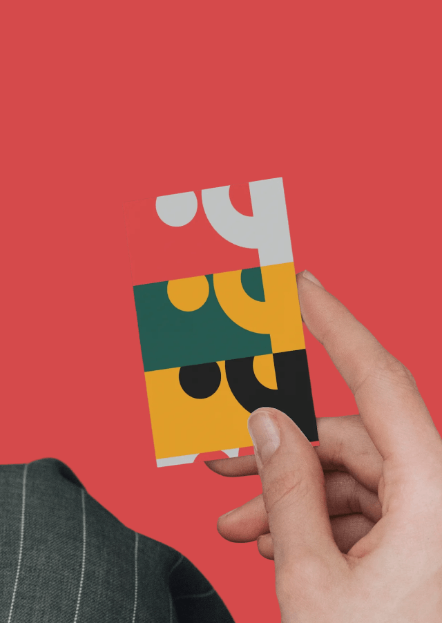 TygrLabs patterned business card held over a pinstripe suit